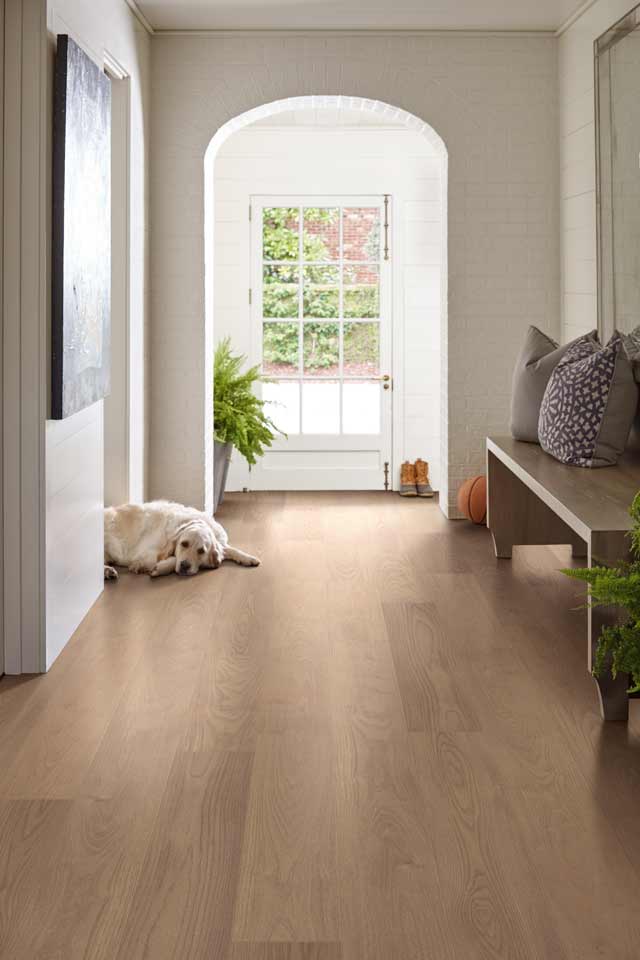 light white oak hardwood in entryway with curved archway of white brick